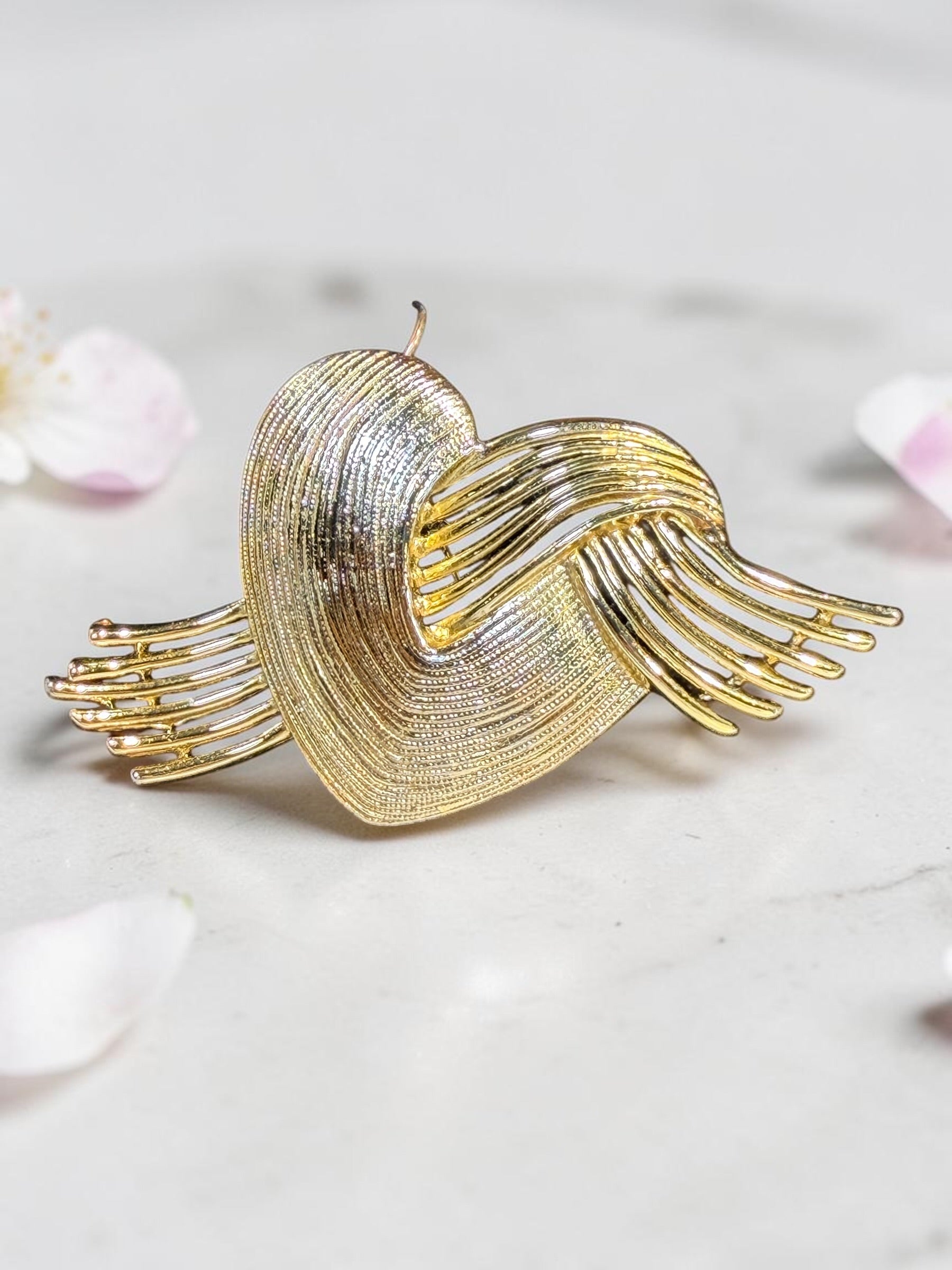 A.J.C. GOLD TONE FLYING HEART BROOCH